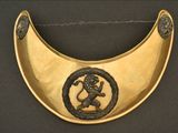brass plate with an image of a lion and a snake on it