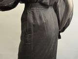 an image of a mannequin wearing a black dress with sheer sleeves