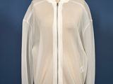a white jacket on a mannequin stand against a blue background