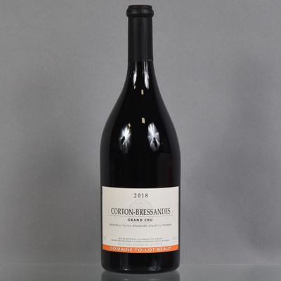 a bottle of red wine sitting on top of a glass table