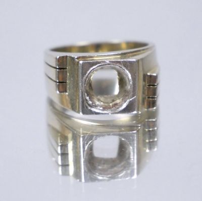 an image of a silver ring on a white surface