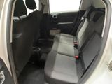 the back seats of a white car with a black seat belt