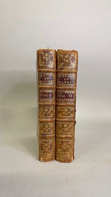 pair of antique leather bound books on a white background
