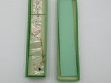 a green box that has a bracelet in it