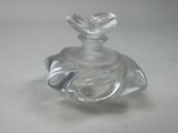 a clear glass bottle with a bird on top of it