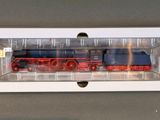 a toy train in a clear box on a table