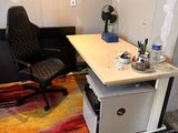 a desk with a chair and a computer on it