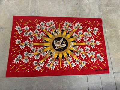 a red rug with a picture of a bird on it