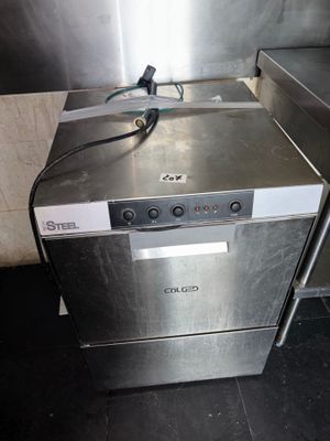 a silver dishwasher sitting on the floor in a kitchen