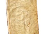 an old book that is sitting on a white surface