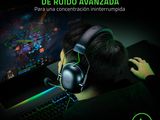 the man is playing a video game on the computer with headphones