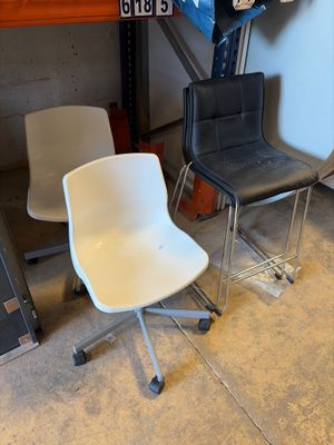 two chairs sitting next to each other in a room
