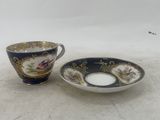 two cups and saucers are sitting on a white surface