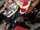 many pairs of shoes in a bag on the floor
