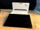 a laptop that is sitting on a table with a box on top of it