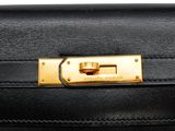 a close up of a black purse with a gold lock