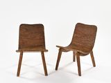 pair of mid - century modern chairs in the style of the early 20th century