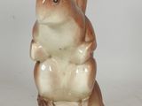 a figurine of a squirrel sitting on top of a table