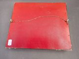 a red piece of paper with a string attached to it