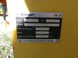 a sign on the side of a yellow machine