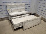 several mattresses are stacked on top of each other in a room