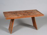 an image of a wooden table with a carved design on it