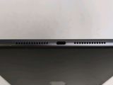 the back of a black tablet computer sitting on top of a white table