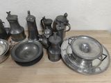 a lot of silver items sitting on a wooden table