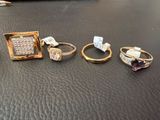 several different rings are sitting on a table next to a pair of scissors