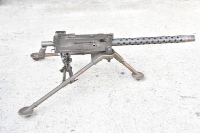 a machine gun that is sitting on a tripod