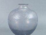 a glass vase that is sitting on a table