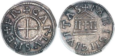 a close up of a coin with a cross on it