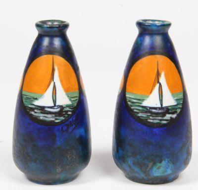 two blue vases with sailboats painted on them