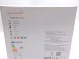 the box of a smart tablet pc is open on a white surface