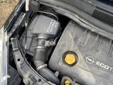 the engine of a car with its hood open on the side of the road