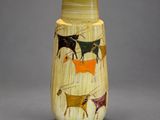 a vase that has a picture of animals on it