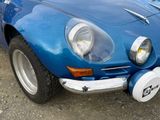 an image of a blue sports car parked on the side of the road