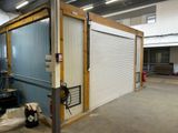 a garage with a door that is open in the middle of a building