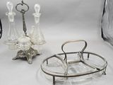 a silver tray with a glass candle holder and a glass candle holder
