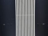an image of a radiator sitting on a wooden floor next to a wall