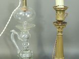 three glass and brass candlesticks and a glass vase on a table