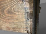 a close up of a knife on a wooden table