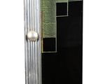 a black and silver vase with three balls on it