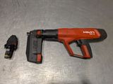 a staple gun and a stapler on a metal surface