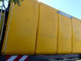 a large yellow container on the back of a truck