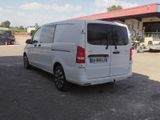 a white van parked in front of a gas station