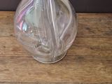 a glass vase with flowers in it on a wooden table