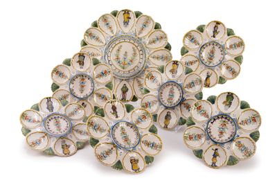 several plates with flowers are arranged on a white surface