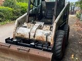 a small tractor that is parked on the side of the road