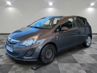 the gray car is parked in the garage on the checkered floor